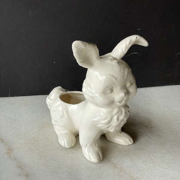 White ceramic bunny-shaped planter on a gray surface