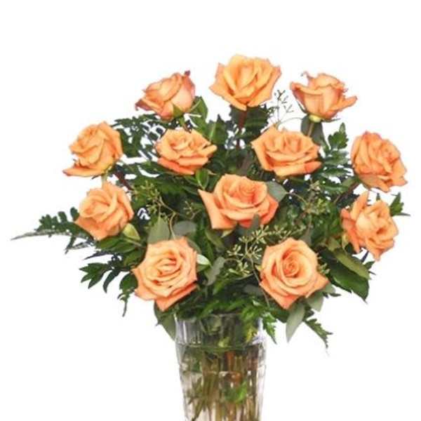 Orange roses arranged in a clear glass vase