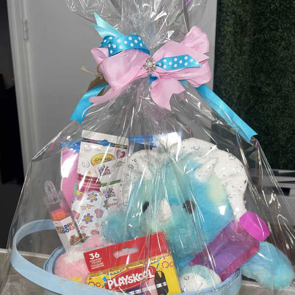 Gift basket with plush toys and crayons wrapped in clear plastic