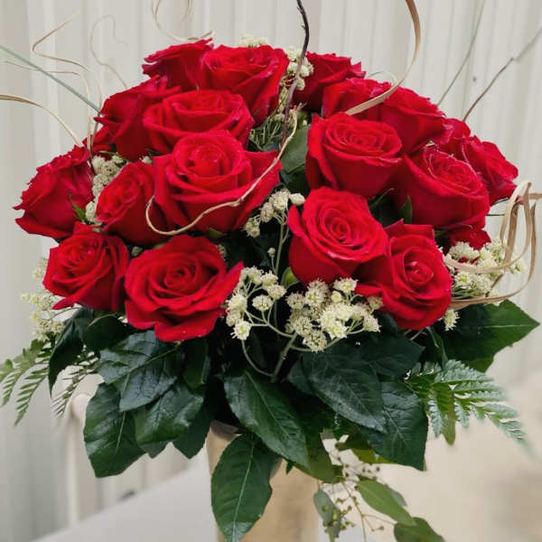 Bouquet of red roses with white filler flowers and greenery