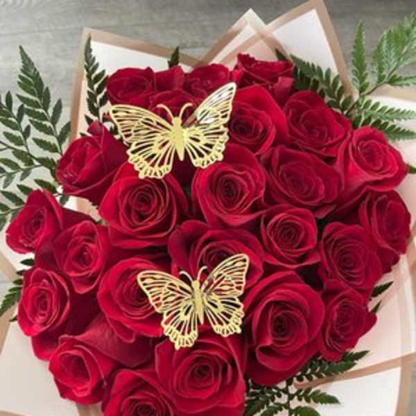 Bouquet of red roses with butterfly accents in white wrapping