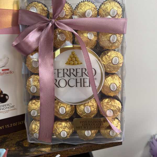 Box of Ferrero Rocher chocolates tied with a pink ribbon