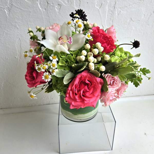 Mixed pink and white flower arrangement in a glass vase