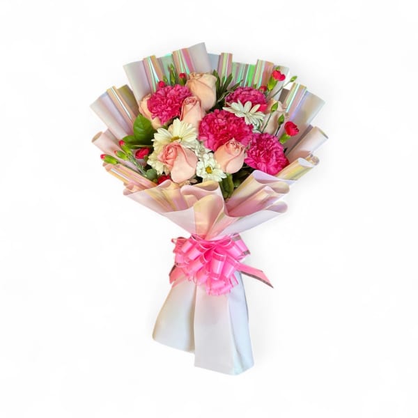 Bouquet of pink and cream flowers wrapped in iridescent paper with a pink ribbon