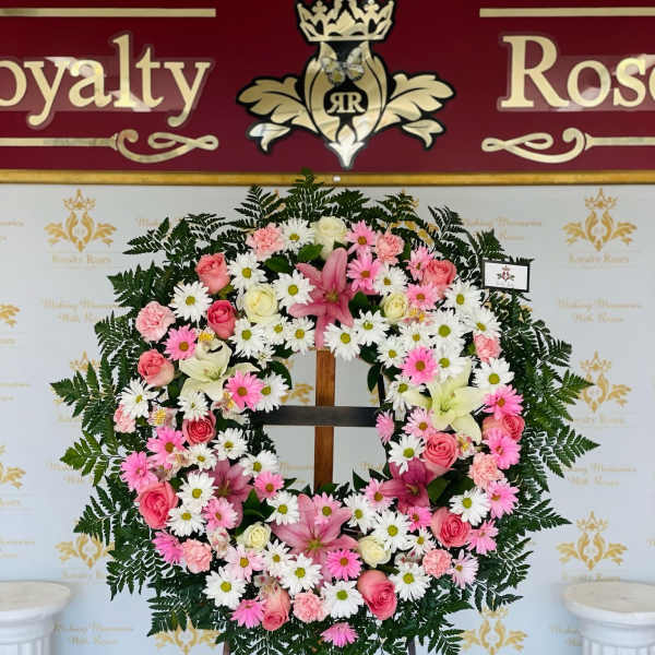 Pink and white floral wreath on a standing easel