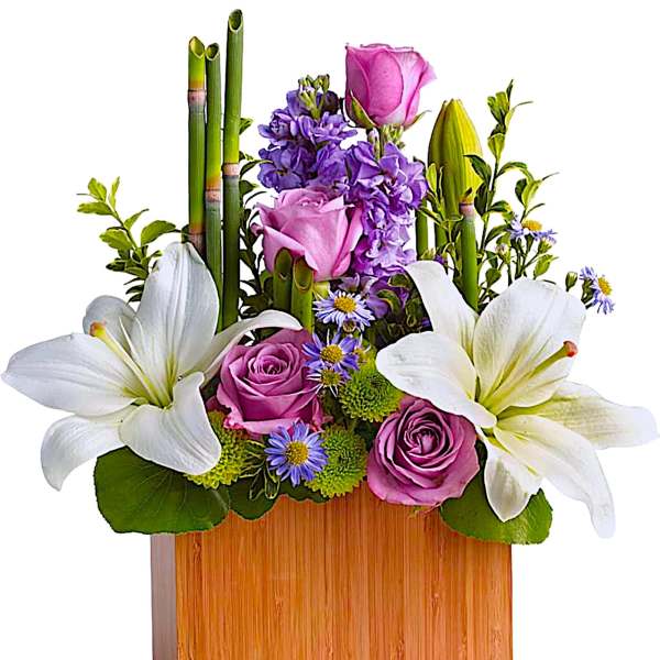 Pink and white flowers arranged in a wooden box