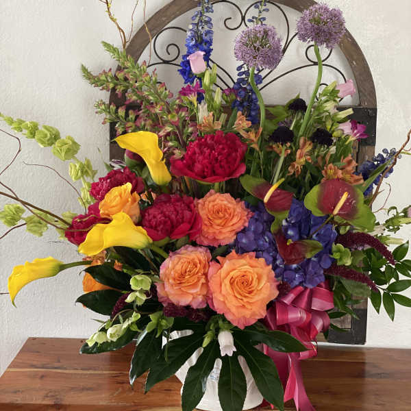 Colorful mixed flower arrangement with roses, calla lilies, and hydrangeas