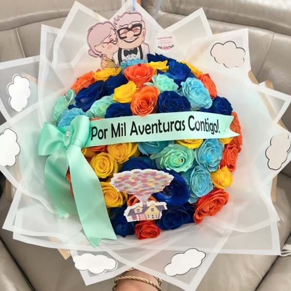 Colorful rose bouquet with a ribbon and a cartoon topper