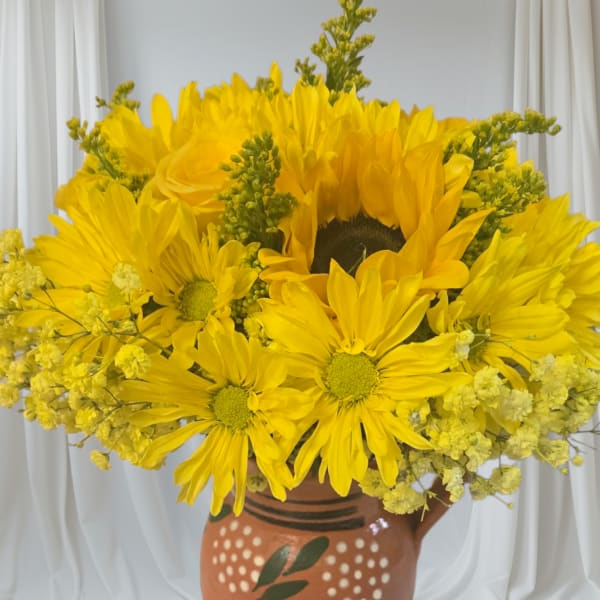 Yellow daisy bouquet in a painted terracotta vase