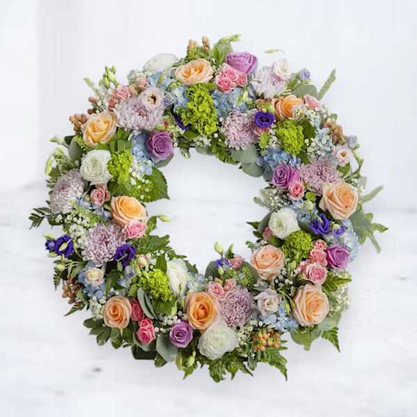 Circular floral wreath with pastel roses and mixed blooms