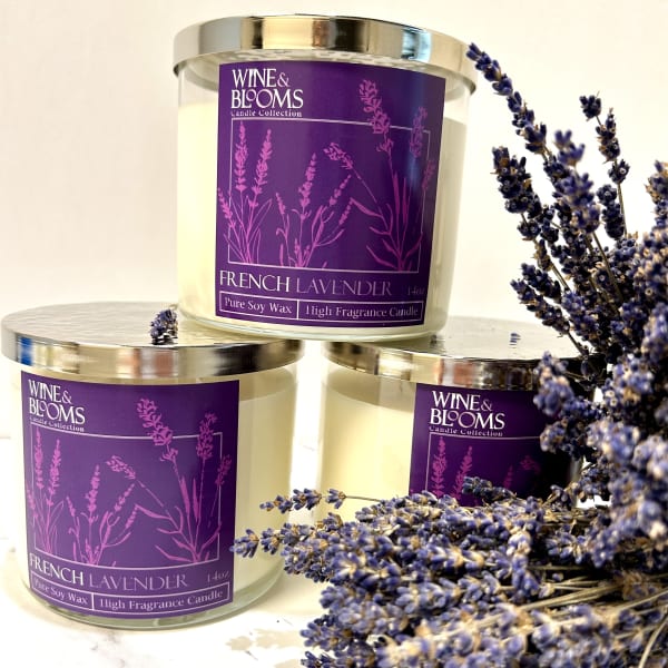 Three lavender-scented candles with a sprig of dried lavender