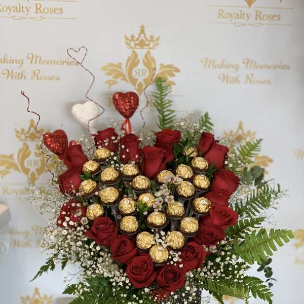 Heart-shaped rose arrangement with gold-wrapped chocolates in a black box