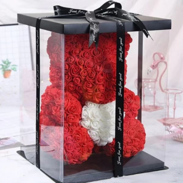 Red rose teddy bear in a clear gift box with a black ribbon