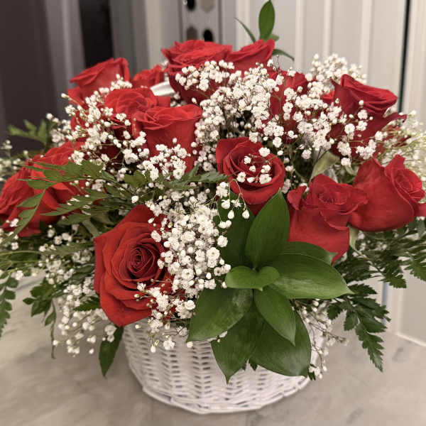 Red roses and baby's breath in a white basket