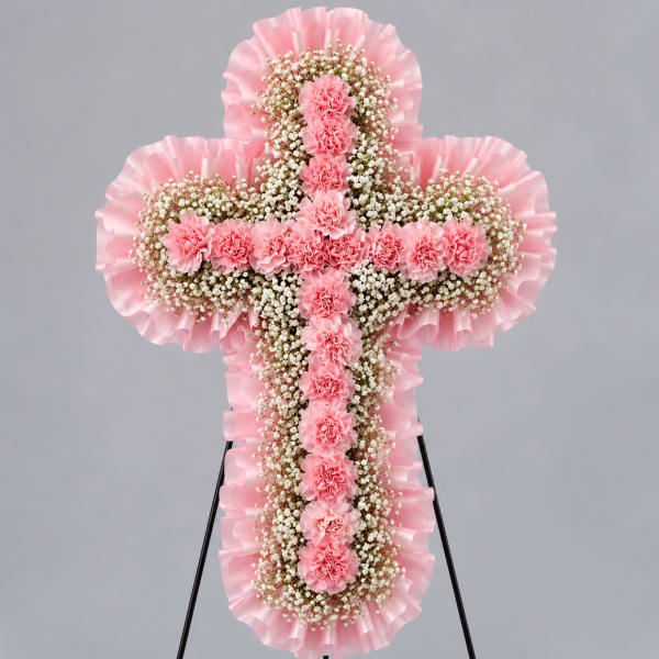 Pink floral cross-shaped standing arrangement on an easel