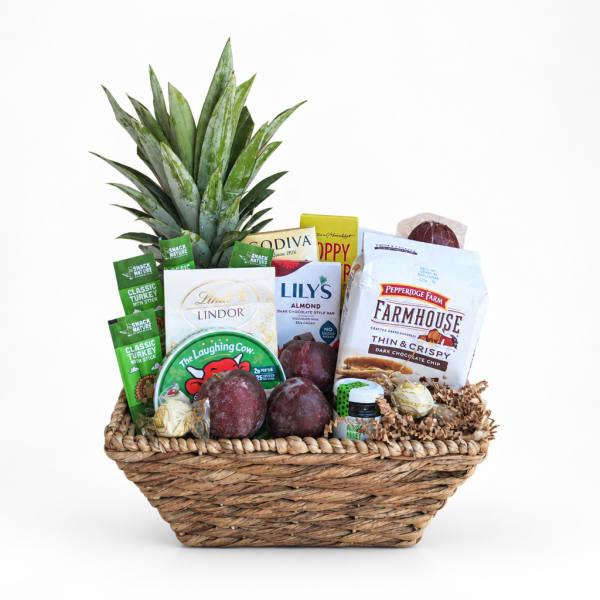 Gift basket with pineapple leaves and assorted snacks and chocolates