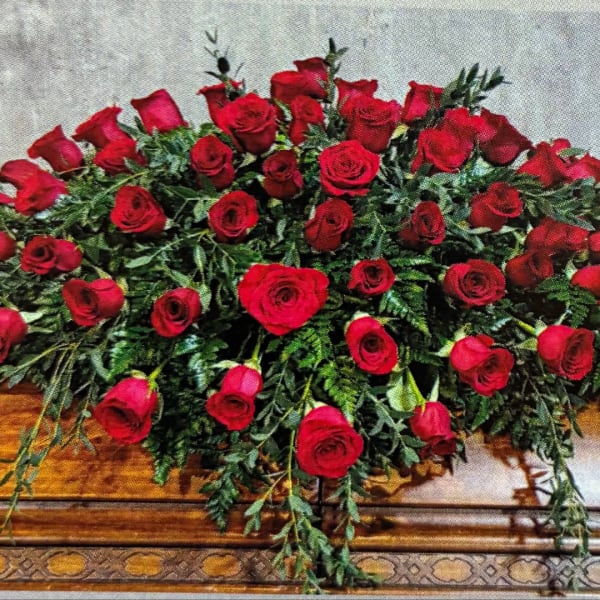 Large arrangement of red roses with cascading greenery