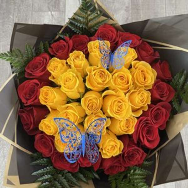 Bouquet of red and yellow roses with decorative butterfly picks