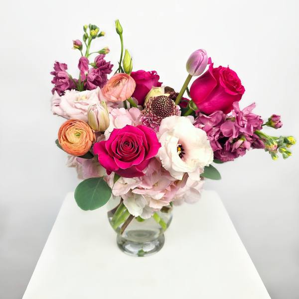 Mixed pink and purple bouquet in a clear glass vase