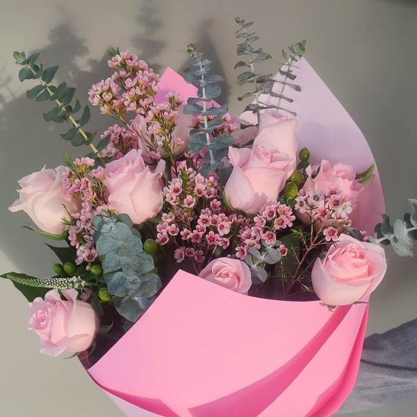 Pink rose bouquet wrapped in bright pink paper