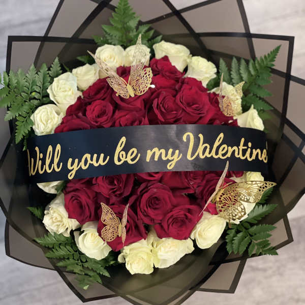 Bouquet of red and white roses with a Valentine ribbon