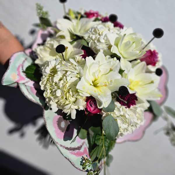 Bouquet of white lilies and pink roses with pale hydrangea