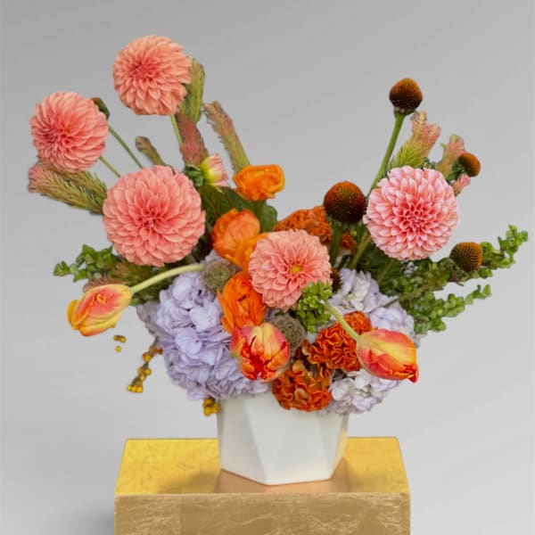 Colorful mixed flower arrangement in a white vase