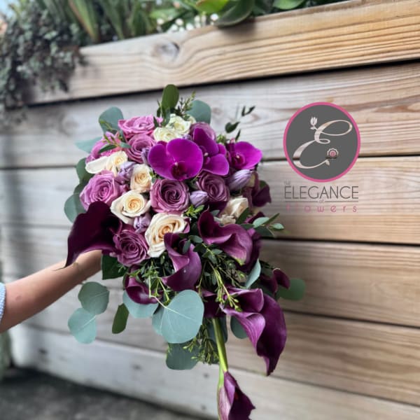Bouquet of purple roses and calla lilies with eucalyptus