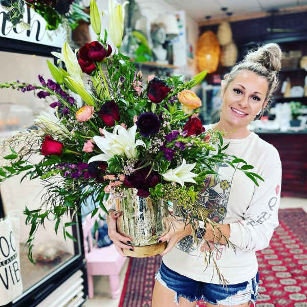 Large mixed bouquet in a glass vase with lilies and roses