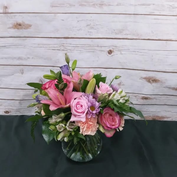 Pink and purple mixed bouquet in a glass vase