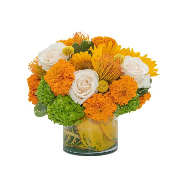 Orange and white flower arrangement in a glass vase