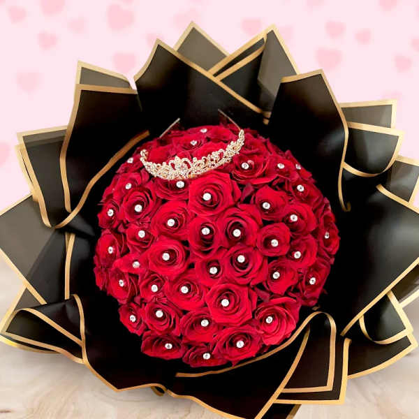 Red rose bouquet with a jeweled crown and black wrapping