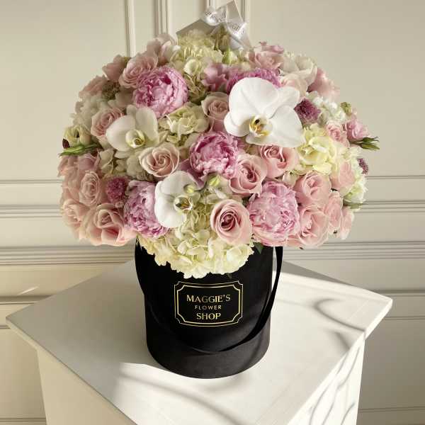 Pink and white bouquet in a black hat box