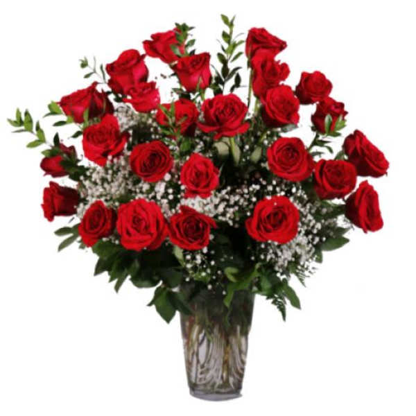 Bouquet of red roses with baby's breath in a clear glass vase
