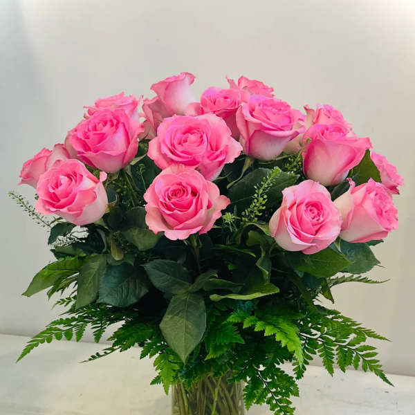Pink roses arranged in a clear glass vase
