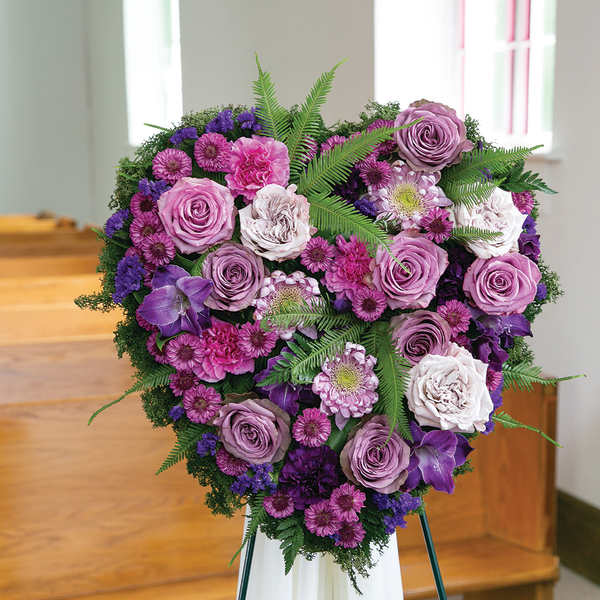 Heart-shaped purple and pink floral spray on an easel