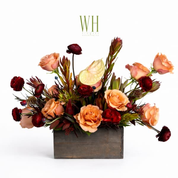 Peach and burgundy floral arrangement in a wooden box