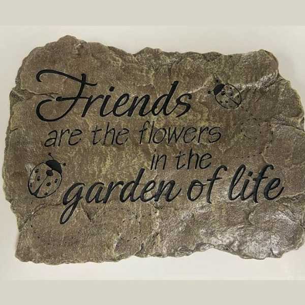 Decorative stone plaque with the quote "Friends are the flowers in the garden of life"