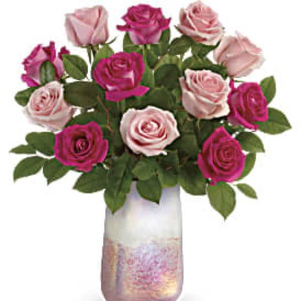 Pink and magenta roses in a tall iridescent vase