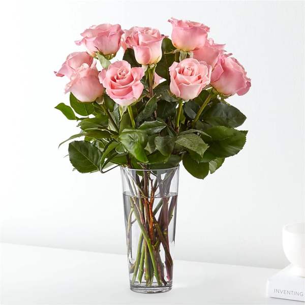 Pink roses arranged in a clear glass vase