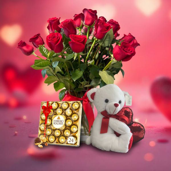 Red roses in a vase with a teddy bear and chocolate box