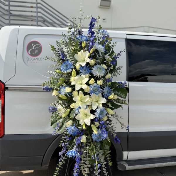 Tall blue and white floral spray on a stand