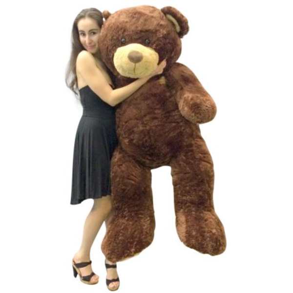Woman hugging a giant brown teddy bear