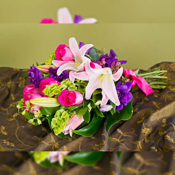 Bouquet of pink roses and white lilies with purple flowers