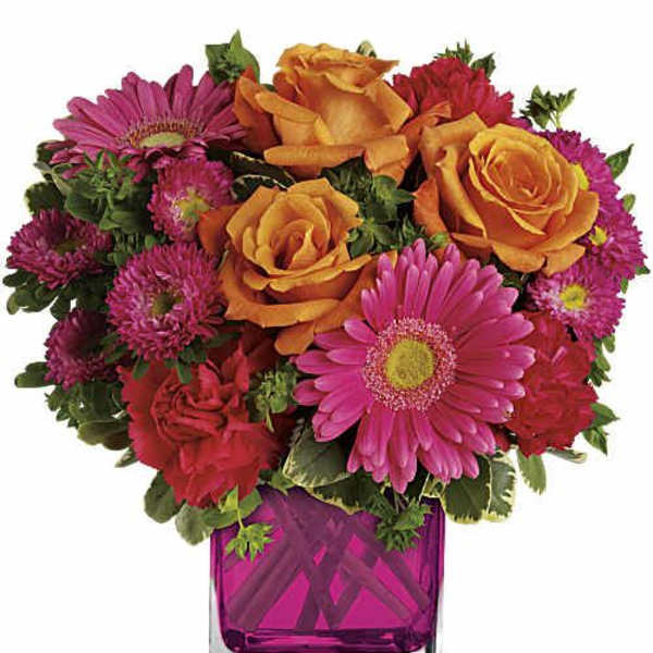 Pink and orange mixed bouquet in a square glass vase