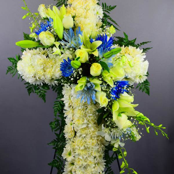 Large white and yellow floral standing spray with blue accents