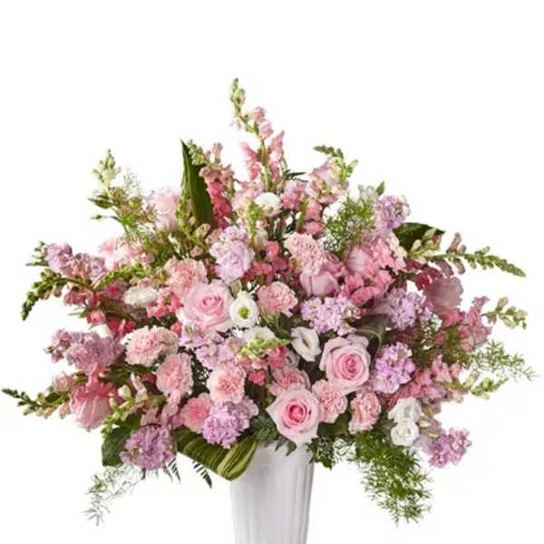 Pink and lavender floral arrangement in a white vase
