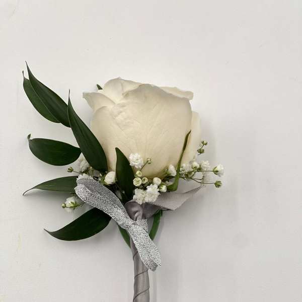 White rose boutonniere with baby's breath and silver ribbon