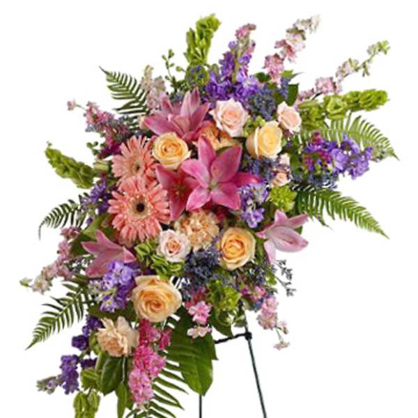 Tall floral standing spray with pink lilies, roses, and purple flowers