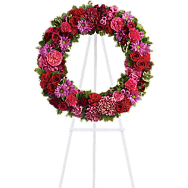 Pink and red floral wreath on a white easel